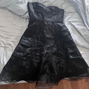 Bcbg size 6 black dress with some purple satin showing behind the lace.